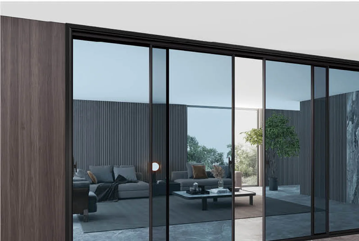 Four-panel black aluminium sliding door in a dusk living room with wood slat wall, design rendering