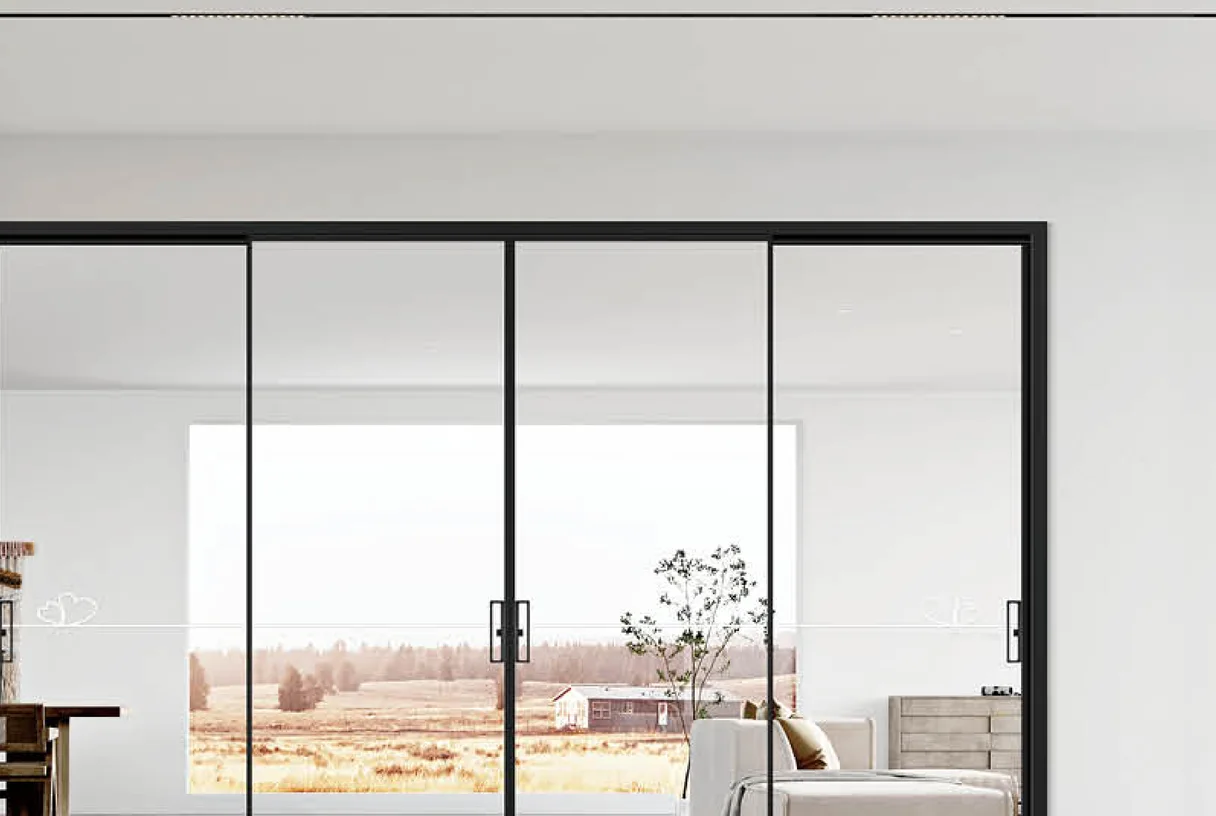 Four-panel black aluminium sliding door in a white room opening onto a field view, design rendering