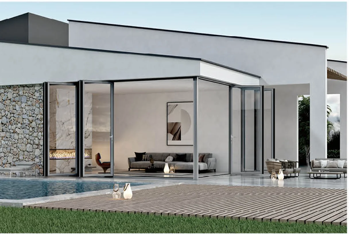Folding aluminium door leaves gathered open beside a villa lounge facing a pool and grass, design rendering