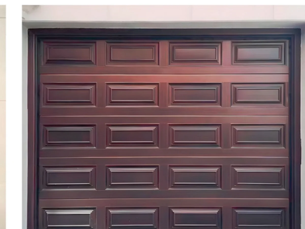 Aluminium raised panel garage door with cooper-style relief on a rendered garage, design rendering