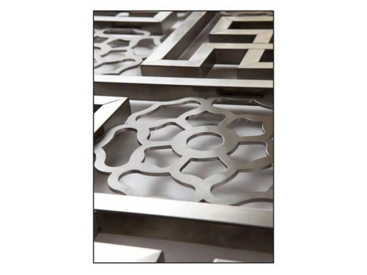 Close-up product shot of the edge of a decorative aluminium lattice panel and its joining section